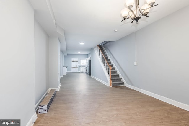 corridor featuring a chandelier and light wood-type flooring