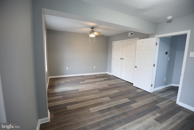 spare room with ceiling fan and dark hardwood / wood-style flooring