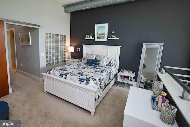 bedroom with light carpet and a high ceiling