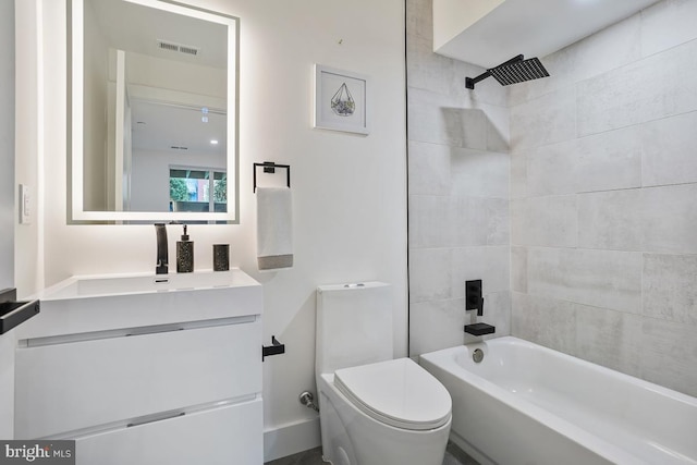 full bathroom with vanity, toilet, and tiled shower / bath