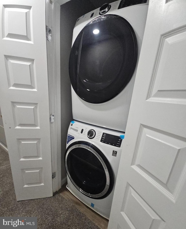 laundry room featuring stacked washer / drying machine