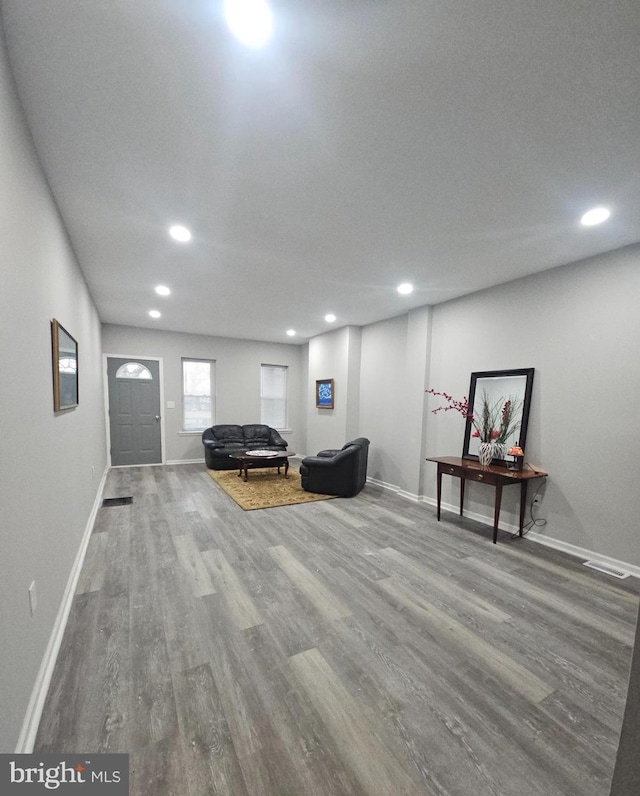 living area featuring a textured ceiling and hardwood / wood-style flooring