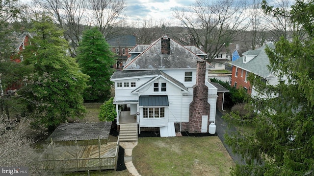 rear view of property with a lawn