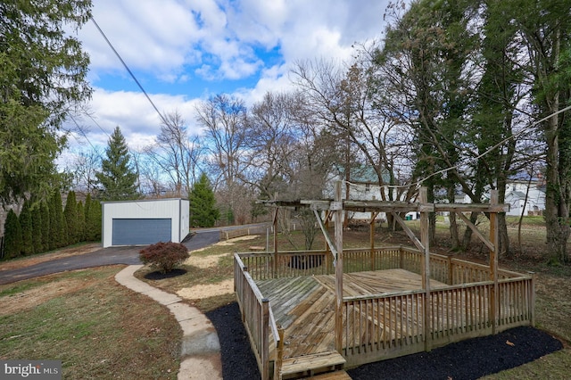 exterior space featuring a deck, an outdoor structure, and a garage