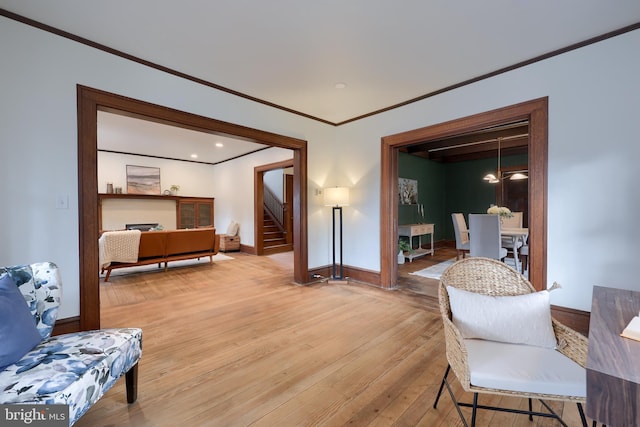 sitting room featuring hardwood / wood-style floors and ornamental molding