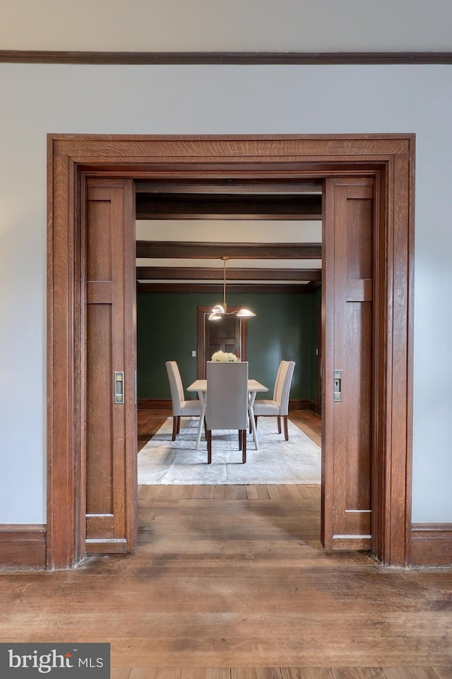 dining area with hardwood / wood-style floors and ornamental molding