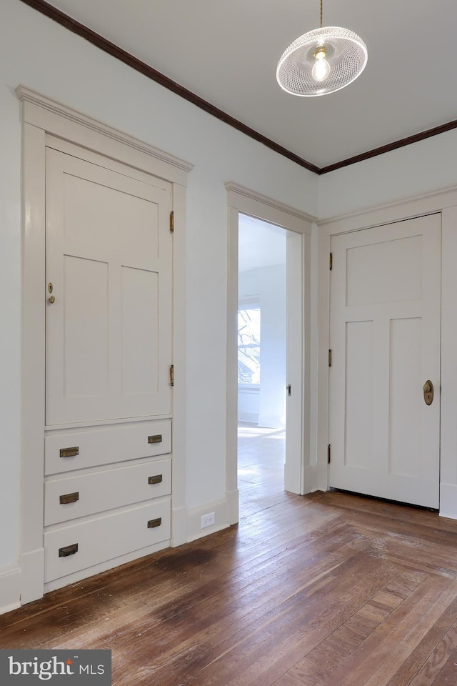 interior space with hardwood / wood-style flooring and ornamental molding