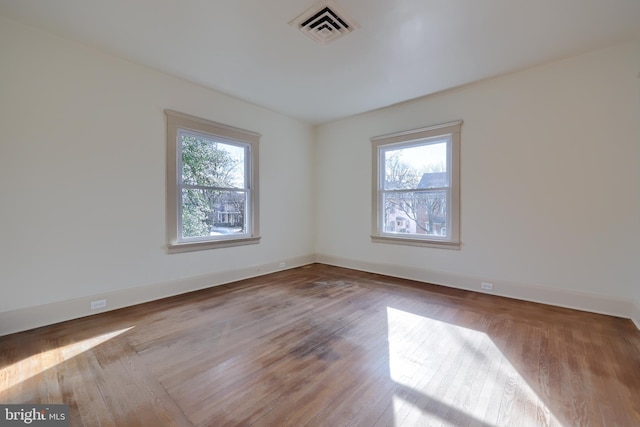 unfurnished room with a wealth of natural light and light wood-type flooring