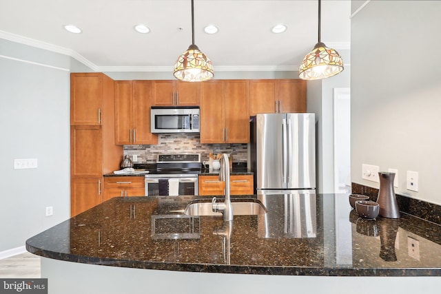 kitchen featuring pendant lighting, tasteful backsplash, dark stone counters, appliances with stainless steel finishes, and ornamental molding