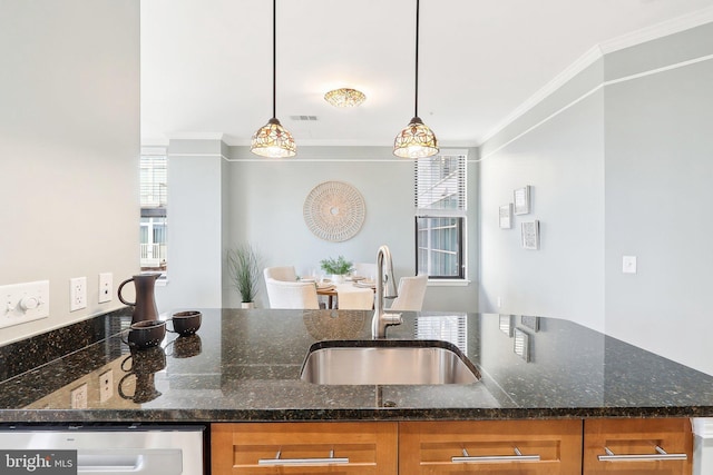 kitchen with dishwasher, pendant lighting, dark stone counters, ornamental molding, and sink