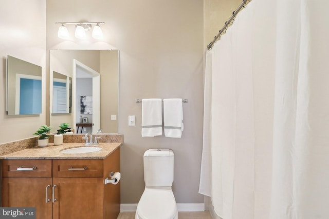 bathroom with toilet and vanity