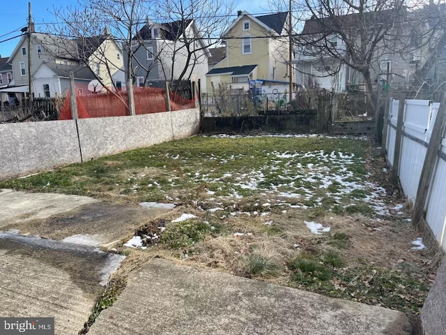 view of yard featuring a residential view and fence