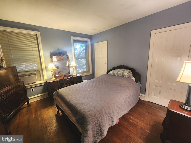 bedroom with dark wood-type flooring