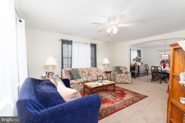 633 E Main St, Fruitland, MD 21826 - carpeted living area with ceiling fan with notable chandelier, arched walkways, and a wealth of natural light