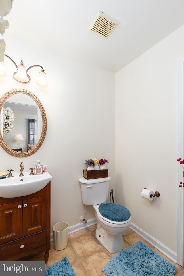 633 E Main St, Fruitland, MD 21826 - bathroom with toilet, vanity, baseboards, visible vents, and tile patterned floors