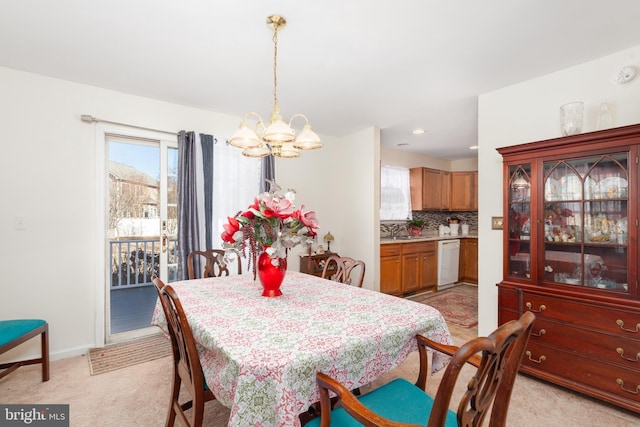 633 E Main St, Fruitland, MD 21826 - dining space featuring a chandelier, light carpet, and baseboards