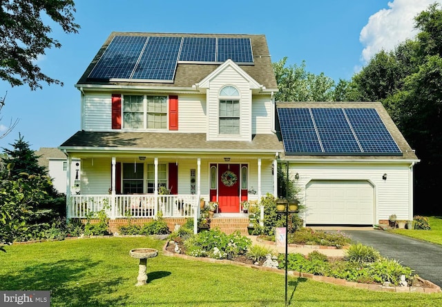 traditional home featuring solar panels, a porch, a front yard, a garage, and driveway