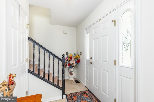 633 E Main St, Fruitland, MD 21826 - foyer featuring stairs, light tile patterned flooring, and baseboards