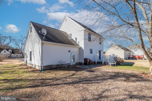 633 E Main St, Fruitland, MD 21826 - rear view of house featuring roof with shingles and a lawn