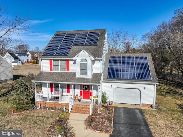 633 E Main St, Fruitland, MD 21826 - traditional-style home with covered porch, driveway, a shingled roof, and roof mounted solar panels