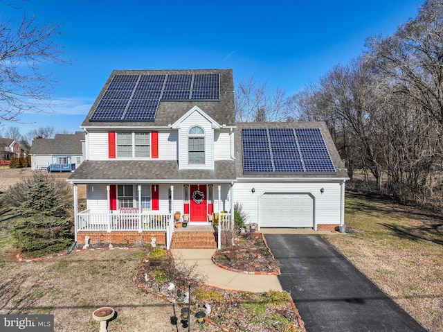 633 E Main St, Fruitland, MD 21826 - traditional home featuring aphalt driveway, roof with shingles, an attached garage, covered porch, and roof mounted solar panels