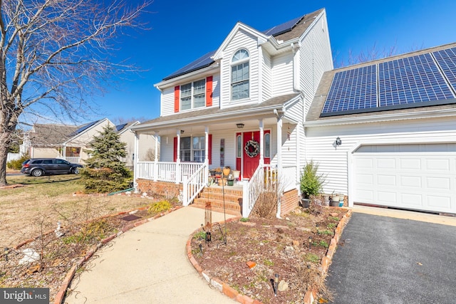 633 E Main St, Fruitland, MD 21826 - traditional-style home featuring a porch, roof mounted solar panels, driveway, and an attached garage