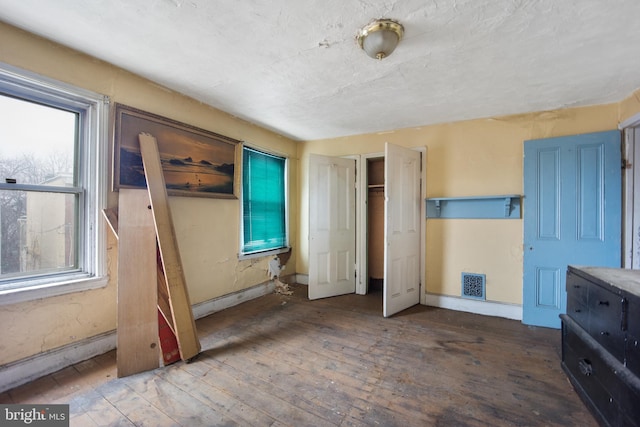 unfurnished bedroom featuring hardwood / wood-style floors