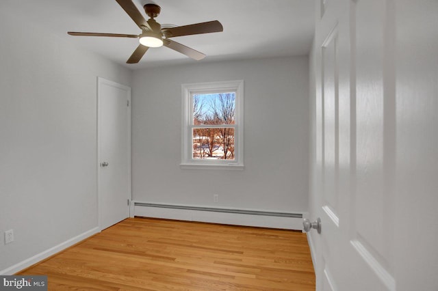 unfurnished room with ceiling fan, light hardwood / wood-style flooring, and a baseboard radiator