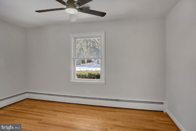 unfurnished room with ceiling fan, a baseboard radiator, and light wood-type flooring