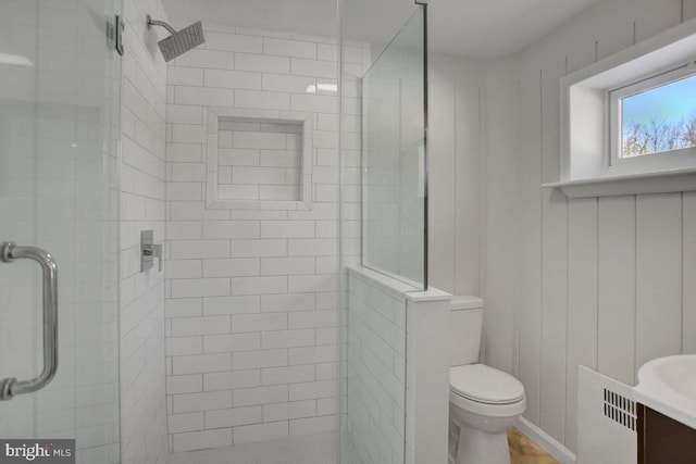 bathroom featuring vanity, toilet, and walk in shower