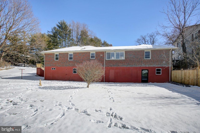 view of snow covered rear of property