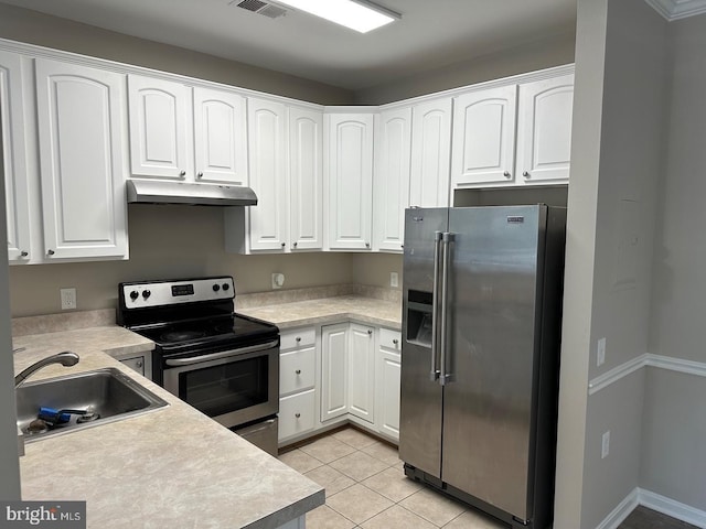 kitchen featuring white cabinets, light tile patterned floors, stainless steel appliances, and sink