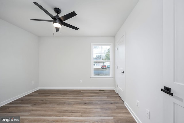 spare room featuring hardwood / wood-style flooring and ceiling fan