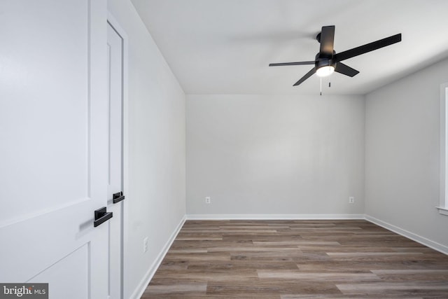 empty room featuring ceiling fan and hardwood / wood-style floors