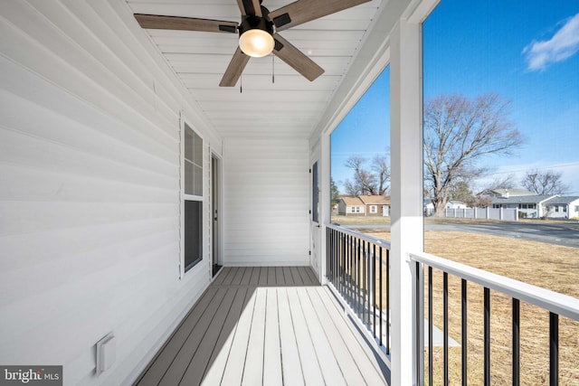 wooden deck with ceiling fan and covered porch