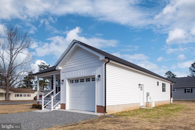 view of property exterior with a lawn, a porch, and a garage