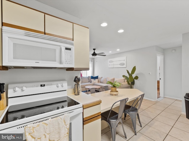 kitchen with ceiling fan, light tile patterned flooring, and white appliances