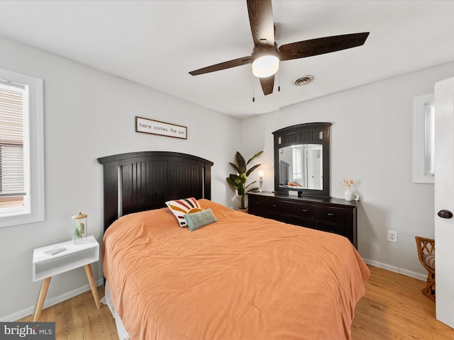 bedroom with ceiling fan and light hardwood / wood-style flooring