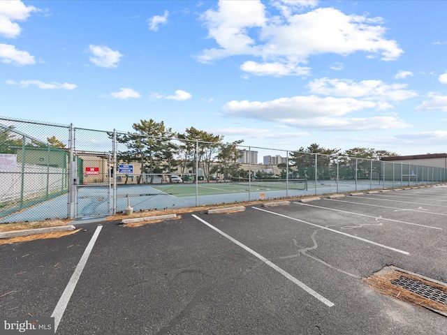 view of parking / parking lot featuring tennis court