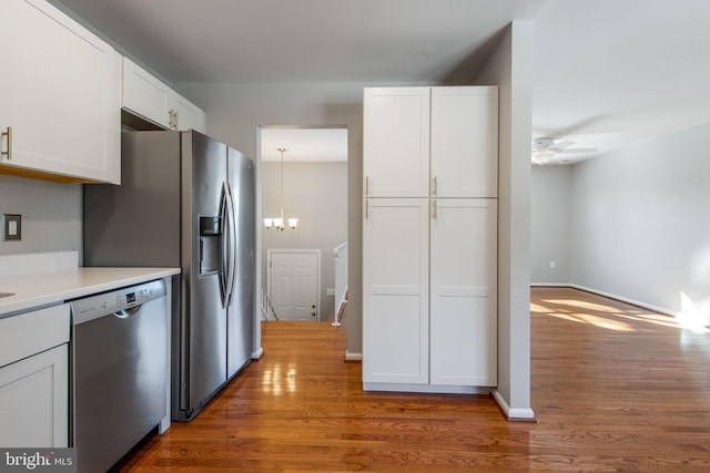 kitchen featuring white cabinetry, dishwasher, and hardwood / wood-style flooring