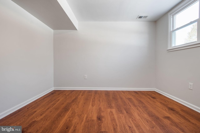 spare room featuring wood-type flooring