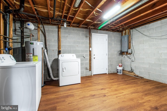 laundry room with hardwood / wood-style floors, electric water heater, electric panel, and washing machine and clothes dryer