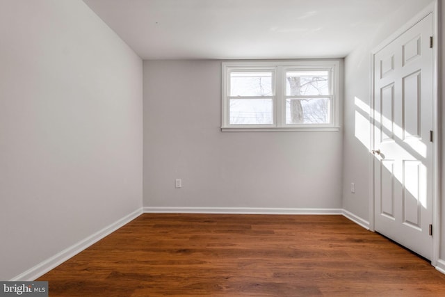 spare room featuring dark hardwood / wood-style floors