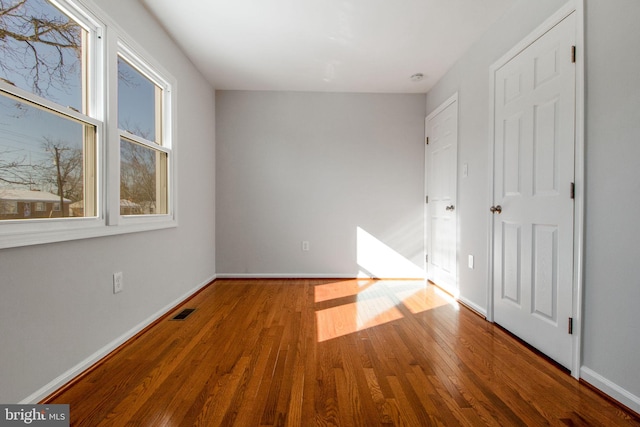 unfurnished bedroom featuring hardwood / wood-style flooring