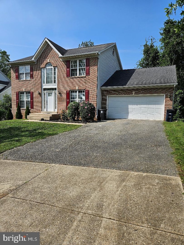 view of front of property with a garage and a front yard