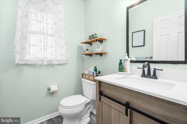 bathroom featuring vanity and toilet