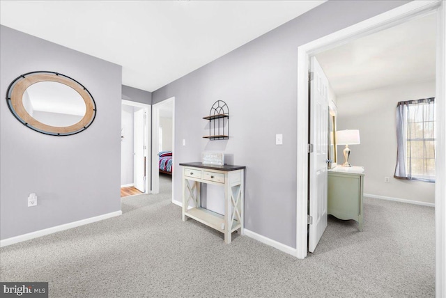 hallway featuring light carpet