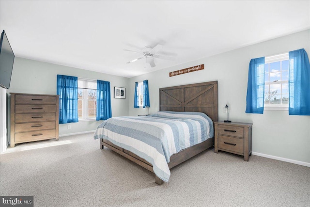 bedroom featuring carpet flooring, multiple windows, and ceiling fan