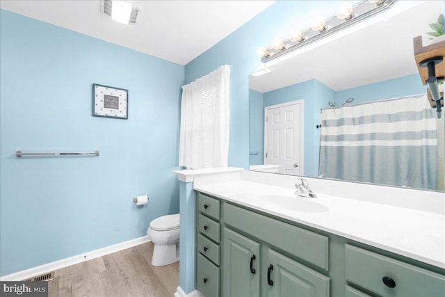 bathroom with a shower with shower curtain, vanity, hardwood / wood-style flooring, and toilet