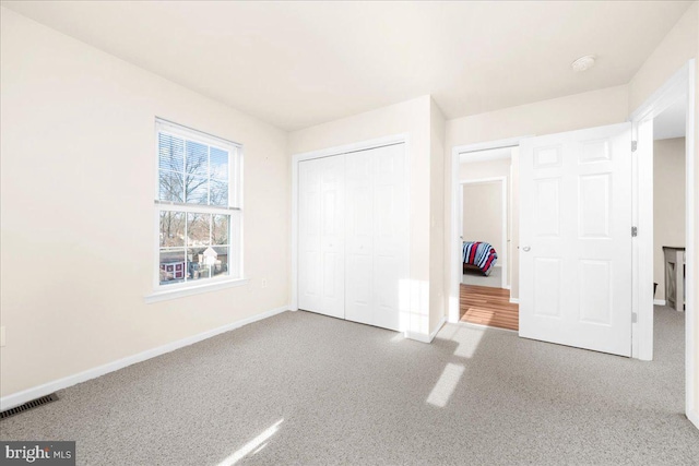 unfurnished bedroom with a closet and carpet floors